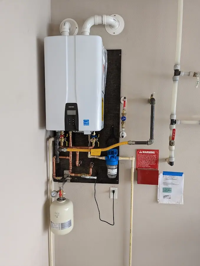 Professional plumber installing copper piping in a Federal Heights home